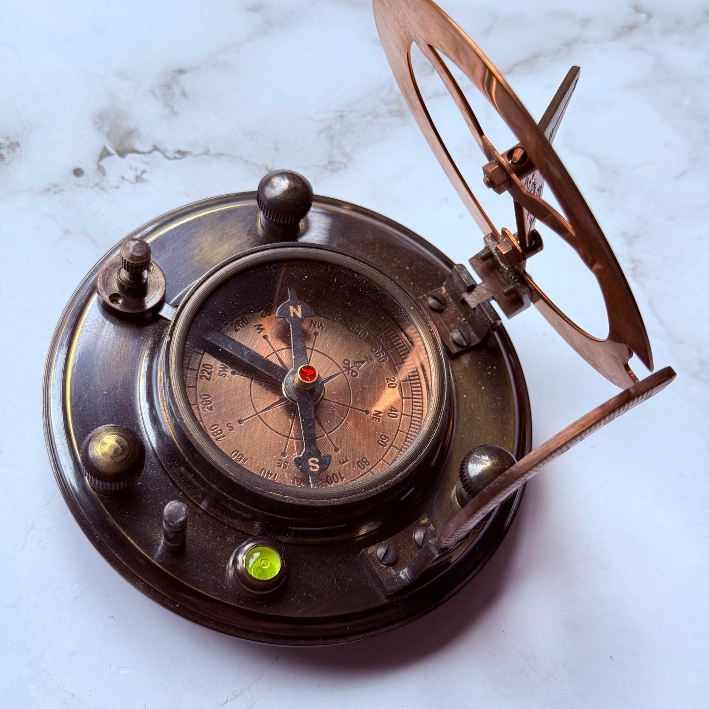 Vintage-style compass on a marble surface