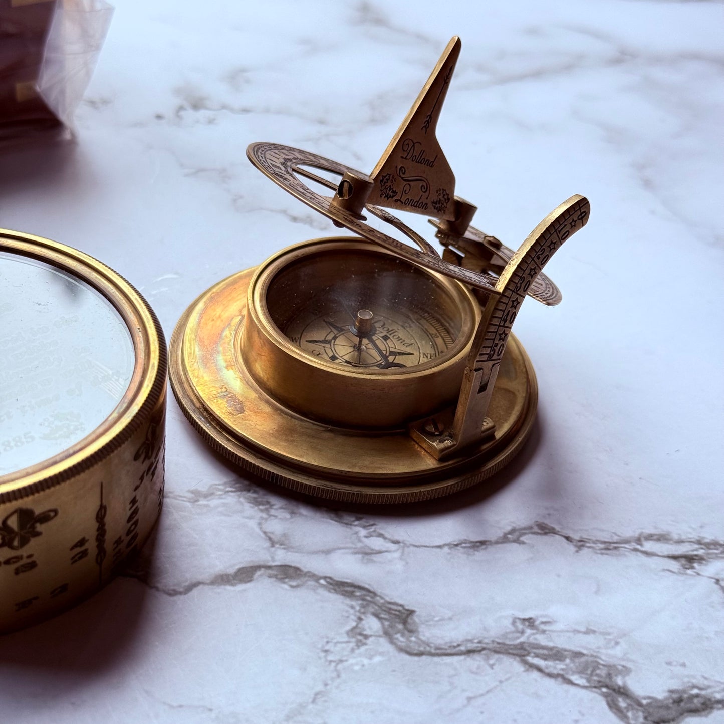 Brass compass on a marble surface