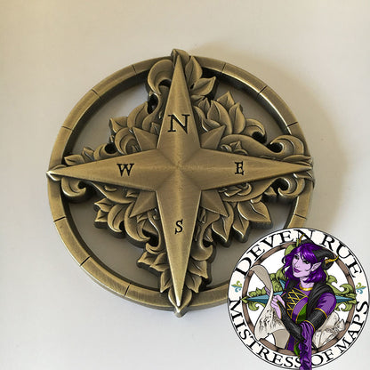 A close up of the Compass Rose token by Deven Rue, front side.