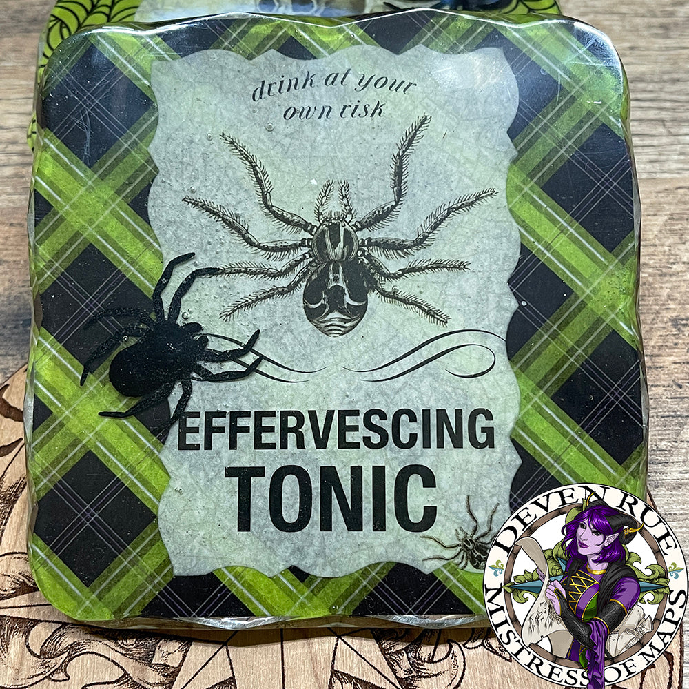 A close up of the "Effervescing Tonic" coaster.
