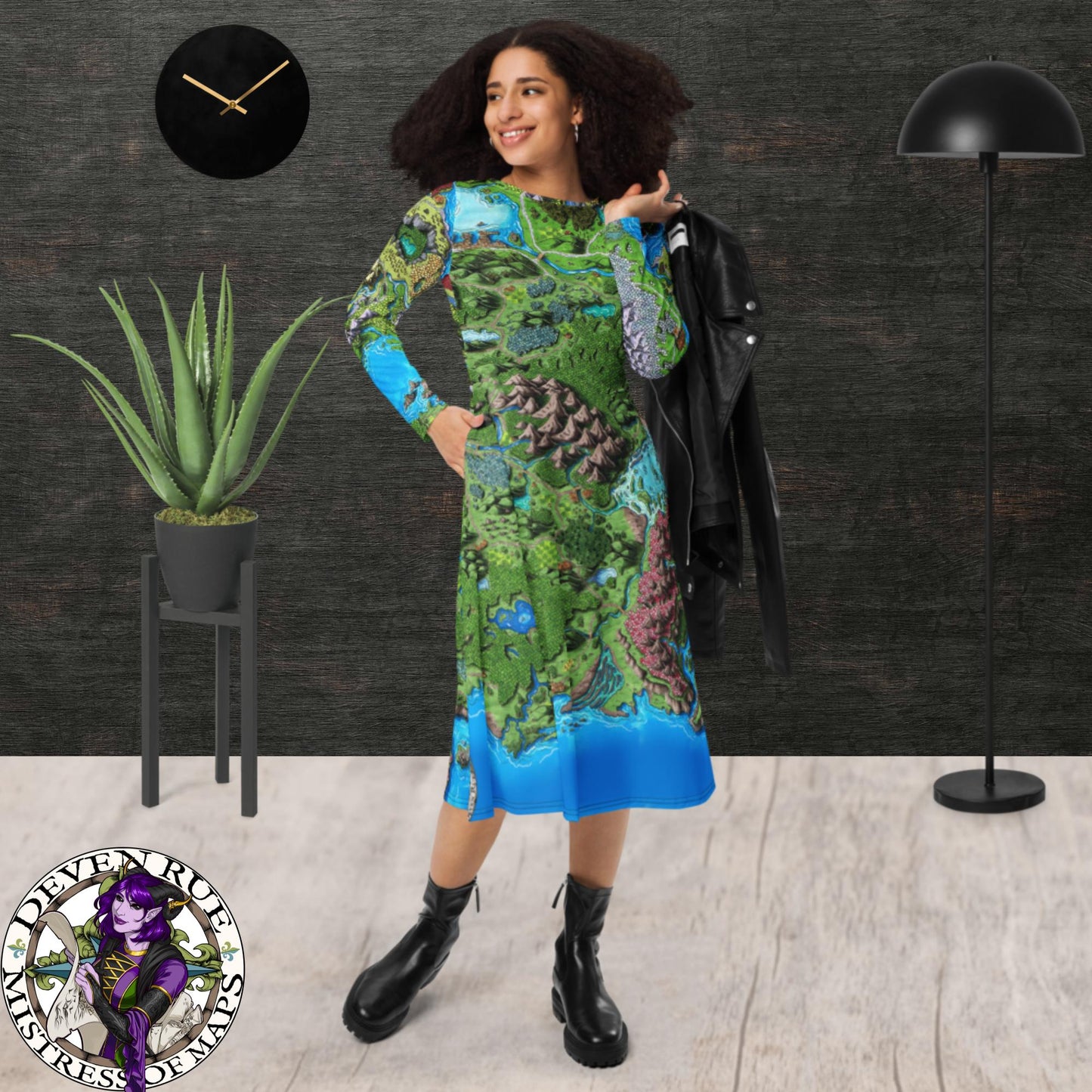 A model wears the Taur'Syldor map on a long sleeve midi dress with a pair of leather boots and a leather jacket.