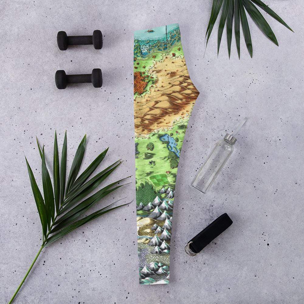 The Queen's Treasure map leggings by Deven Rue sit folded in half with gym accessories.