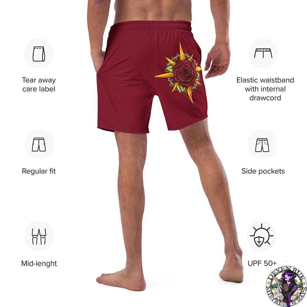 A model wears red swim trunks with the Druid Compass Rose illustration by Deven Rue, surrounded by product specifications.