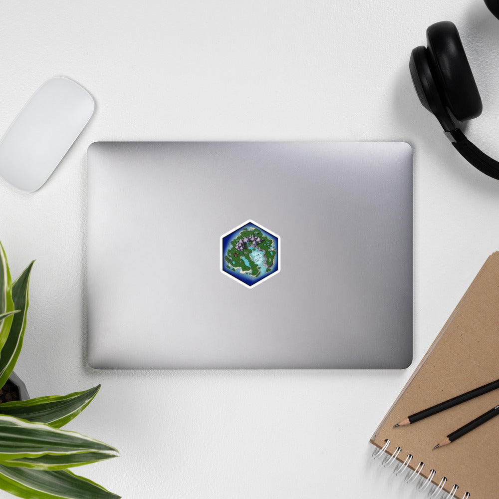 A smaller version of the previously described sticker on the same laptop setup.