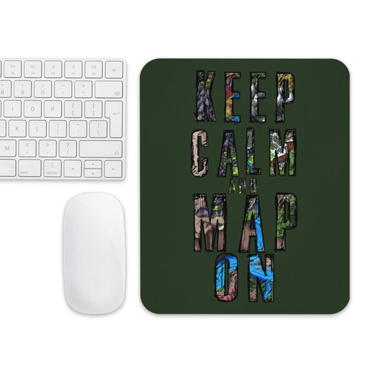 A forest green mousepad with "Keep calm and map on" next to a mouse and keyboard for scale.