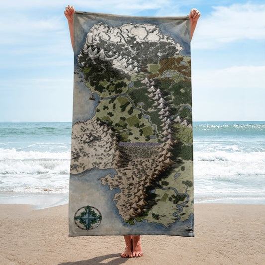 A model holds a towel with the Vendras map by Deven Rue at the beach.