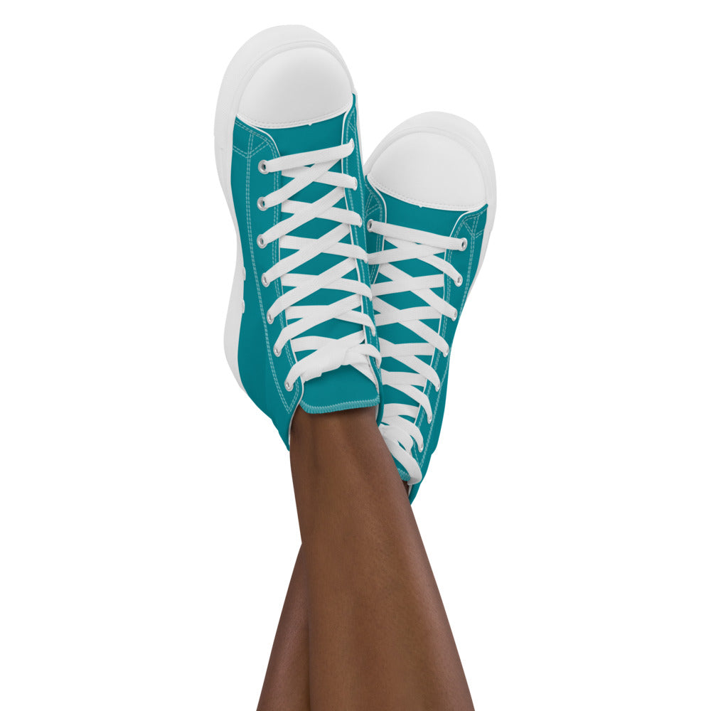 Teal high top shoes with the Discovering the Gate underwater hex map by Deven Rue on the heel, worn by a model.