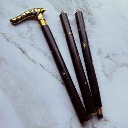 Decorative walking cane handle with brass floral pattern broken down into 3 parts