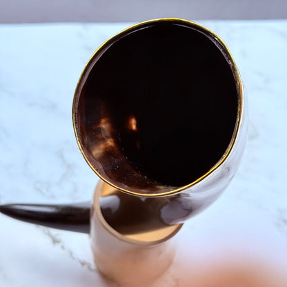 Closeup detail of the gold trimmed mouth of the drinking horn.