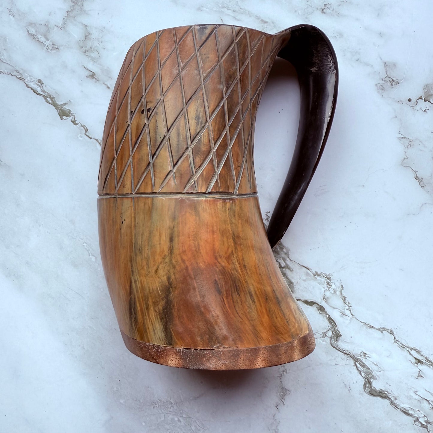 Horn-shaped mug with carved lattice design and curved handle 