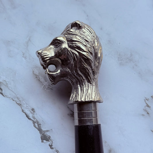 Detailed profile photo of the metal lion shaped handle of the cane