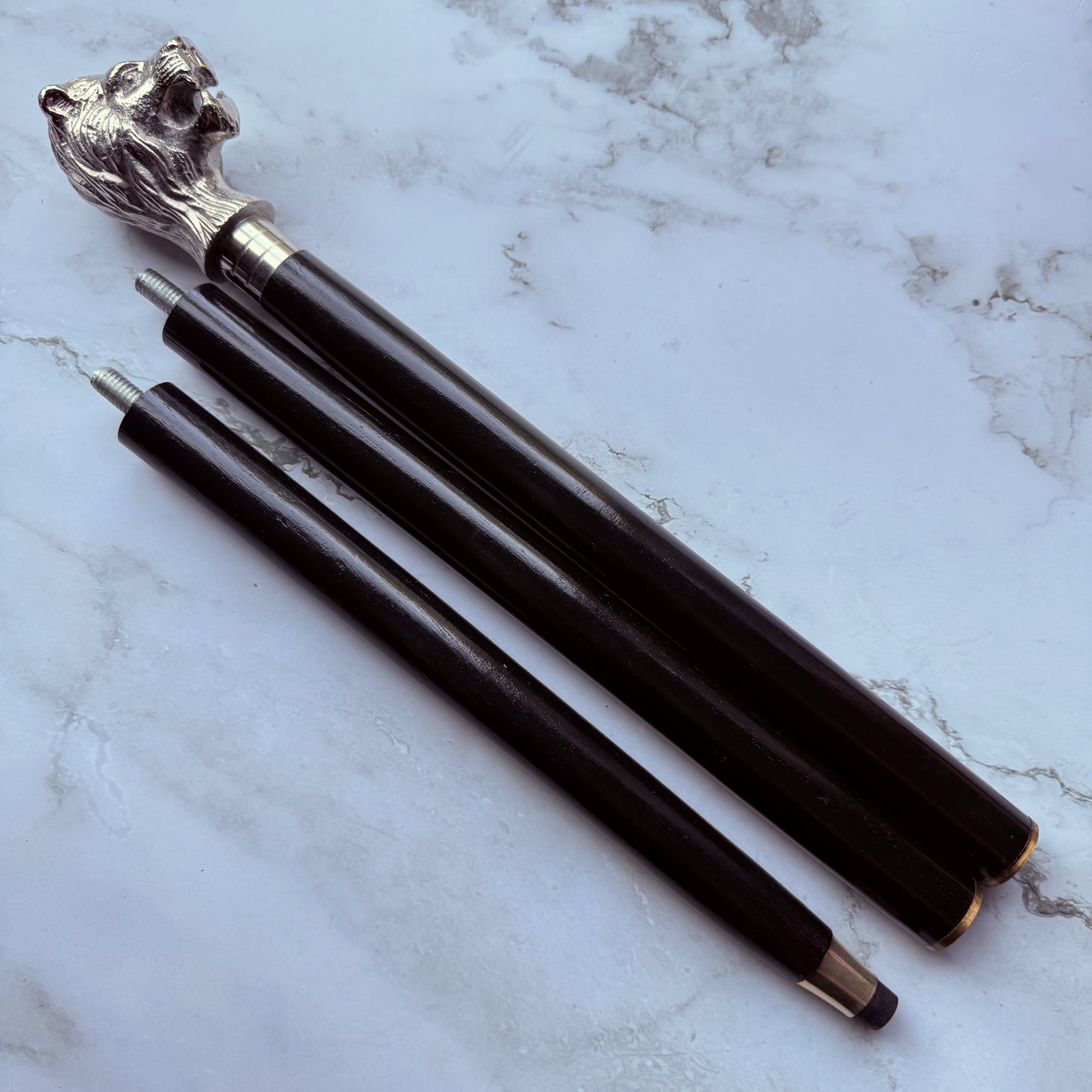 Detailed profile photo of the metal lion shaped handled cane broken down into 3 parts