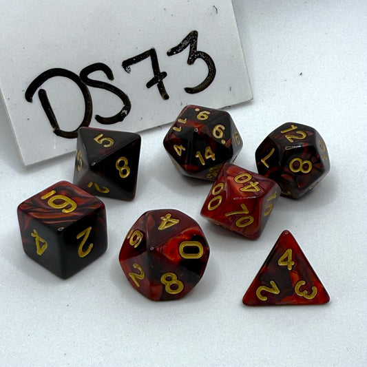 Set of polyhedral dice with red and black marbled pattern on a white background