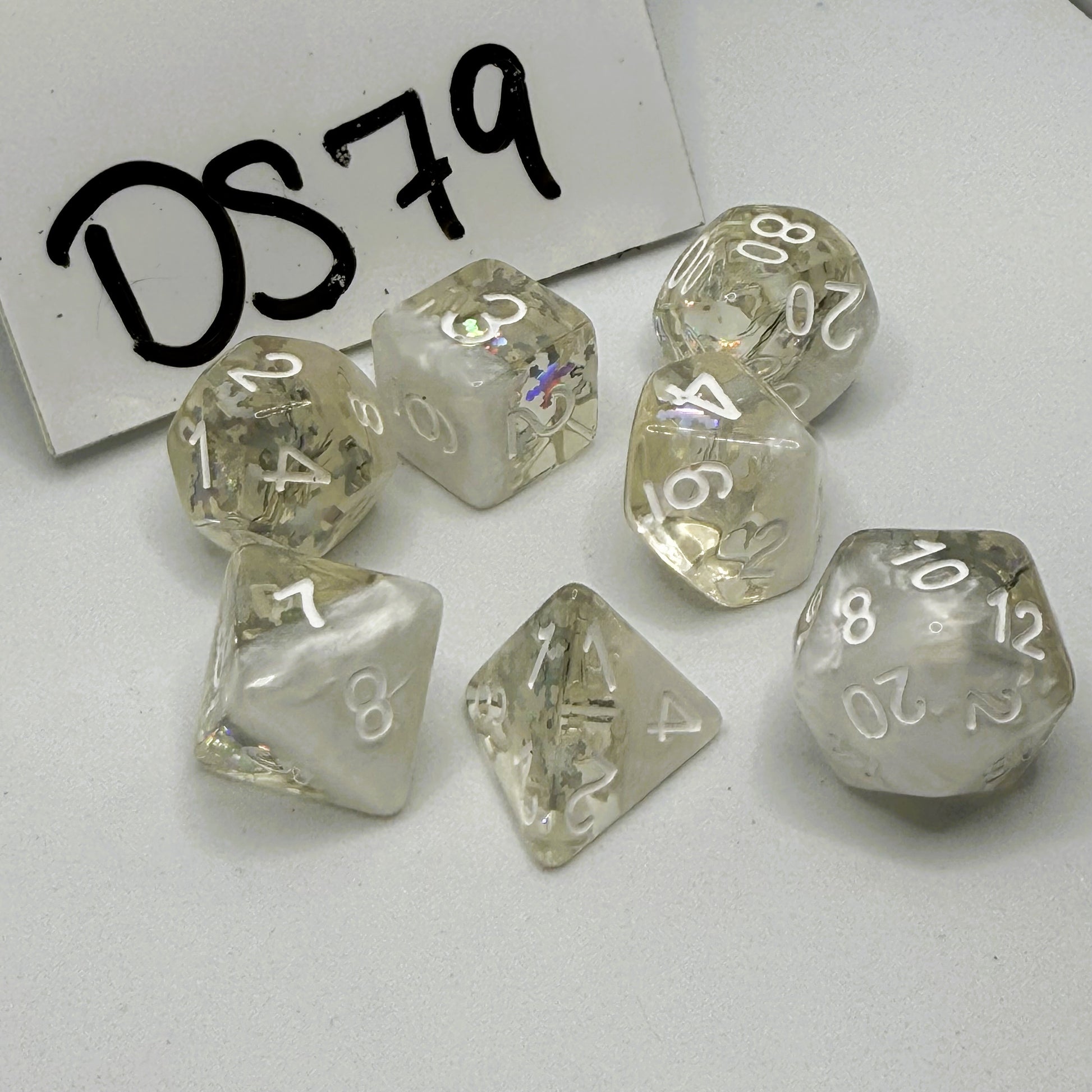 Set of clear & white pearl dice with silver snowflake inclusions and white numbers on a white background, labeled 'DS79'.