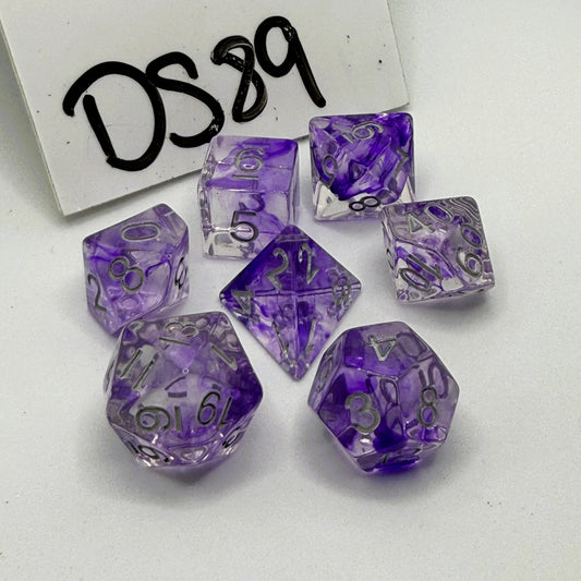Purple and clear polyhedral dice set on a white background labeled 'DS89'