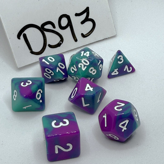 Set of purple and green dice with numbers on a white background