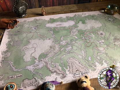 A photo of the Barovia prop map by Deven Rue spread out, surrounded by adventuring gear.