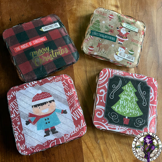 A set of four coasters with Christmas themed decorations including trees, flannel, snowmen, Santa, and more.