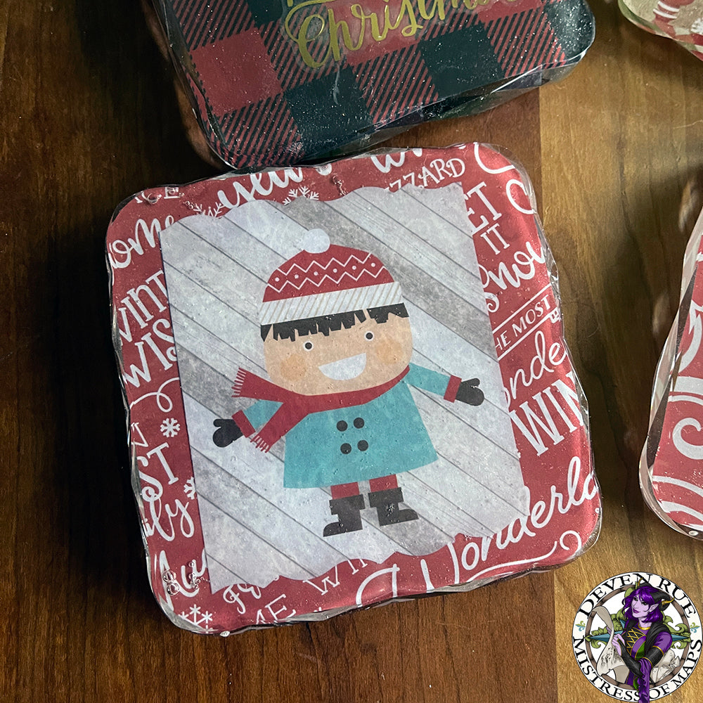 A close up of a coaster with an illustration of a happy kid wearing winter outerwear.