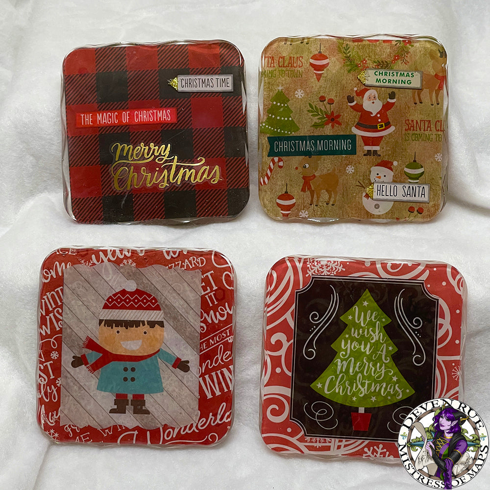 A set of four coasters with Christmas themed decorations including trees, flannel, snowmen, Santa, and more.