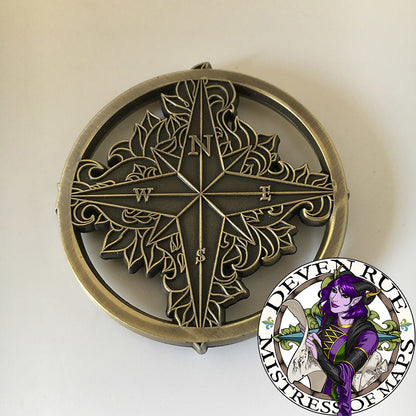 A close up of the back of the Compass Rose token by Deven Rue.