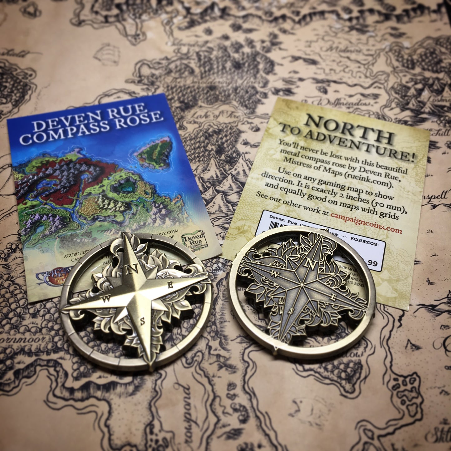 An antique bronze tone compass rose with Deven Rue's card.