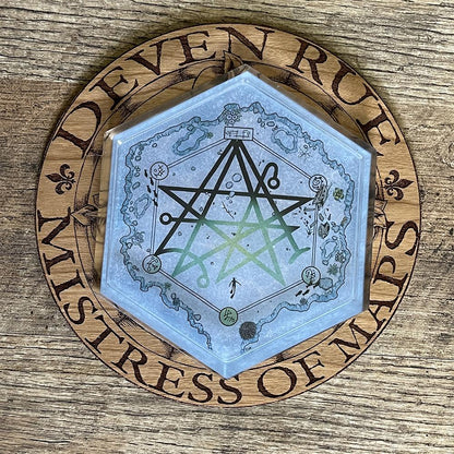 The Discovering the Gate Hex Map coaster on the wooden Deven Rue logo.