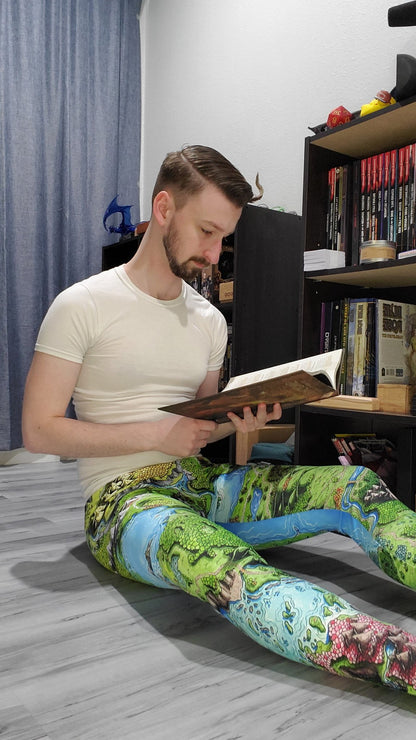 Josh Simons wears the Taur'Syldor map leggings by Deven Rue as he reads a book on his floor.