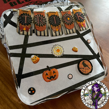 A close up of the third coaster in the set with Trick or Treat designs.