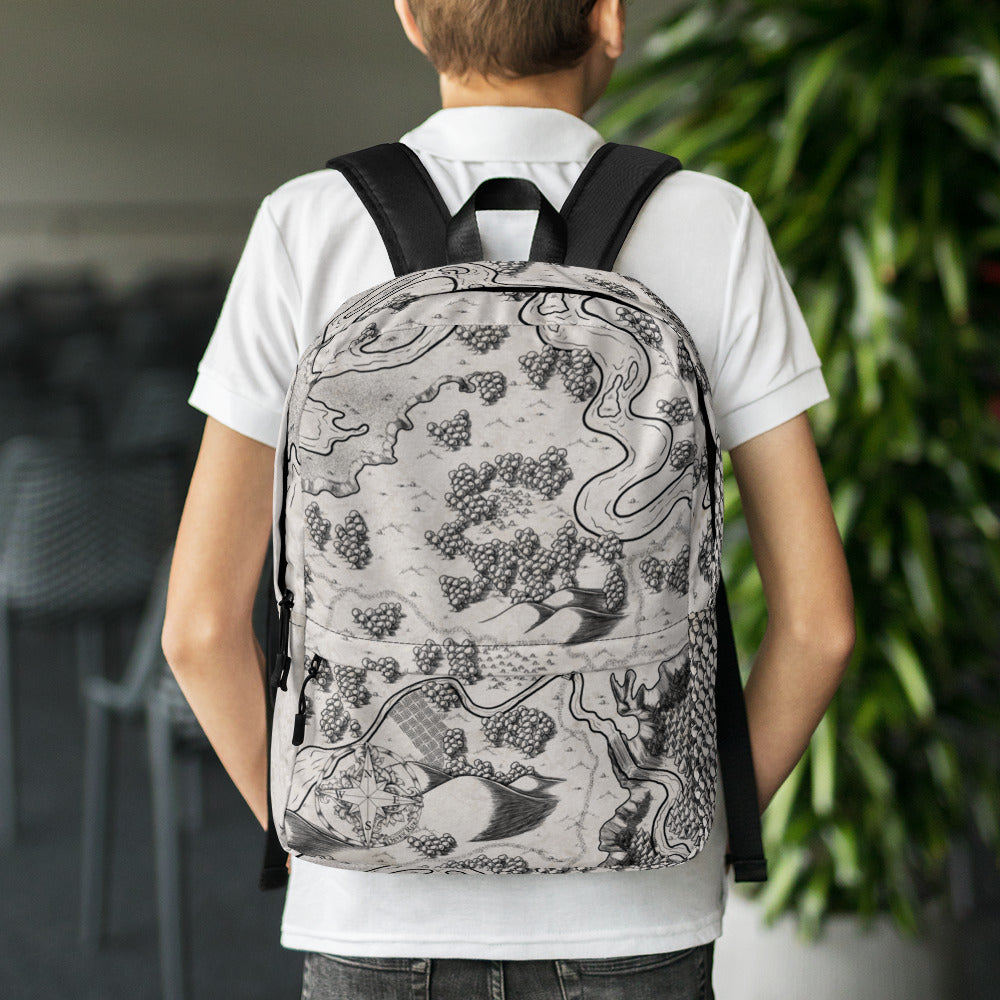 A model wears a backpack with the Humble Beginnings map by Deven Rue printed on it.
