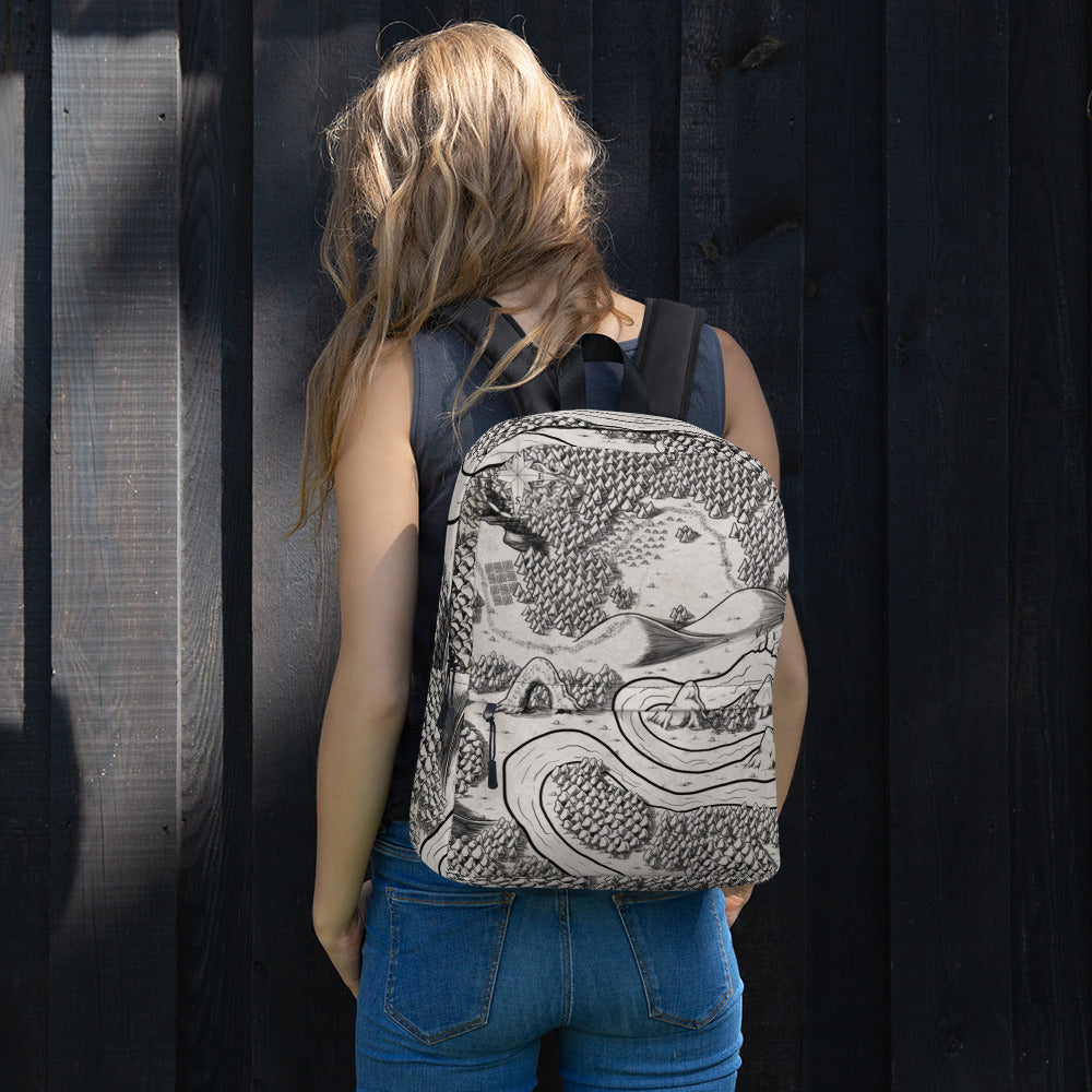 A model wears a backpack with the Magical Arch map by Deven Rue printed on it.