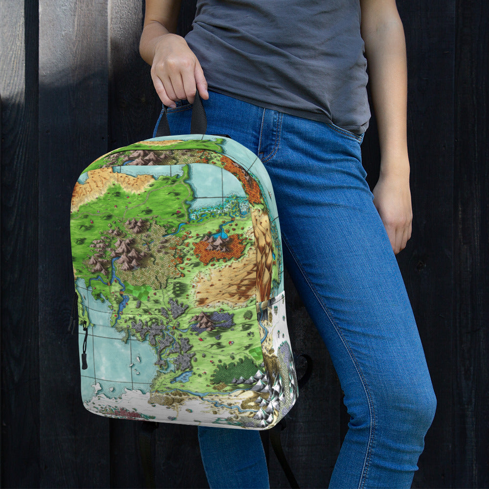 A model holds a backpack with The Queen's Treasure map by Deven Rue printed on it.