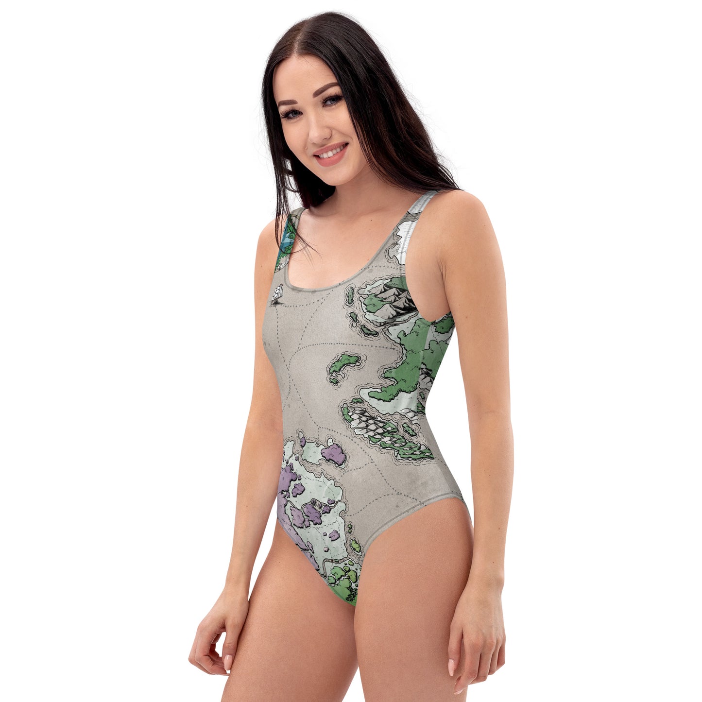 A model wears the Ortheiad map one piece swimsuit by Deven Rue, left view.