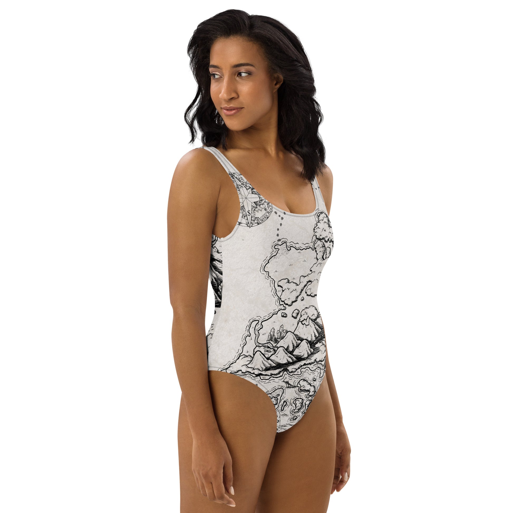 A model wears the Ship Graveyard one piece swimsuit by Deven Rue, right view.