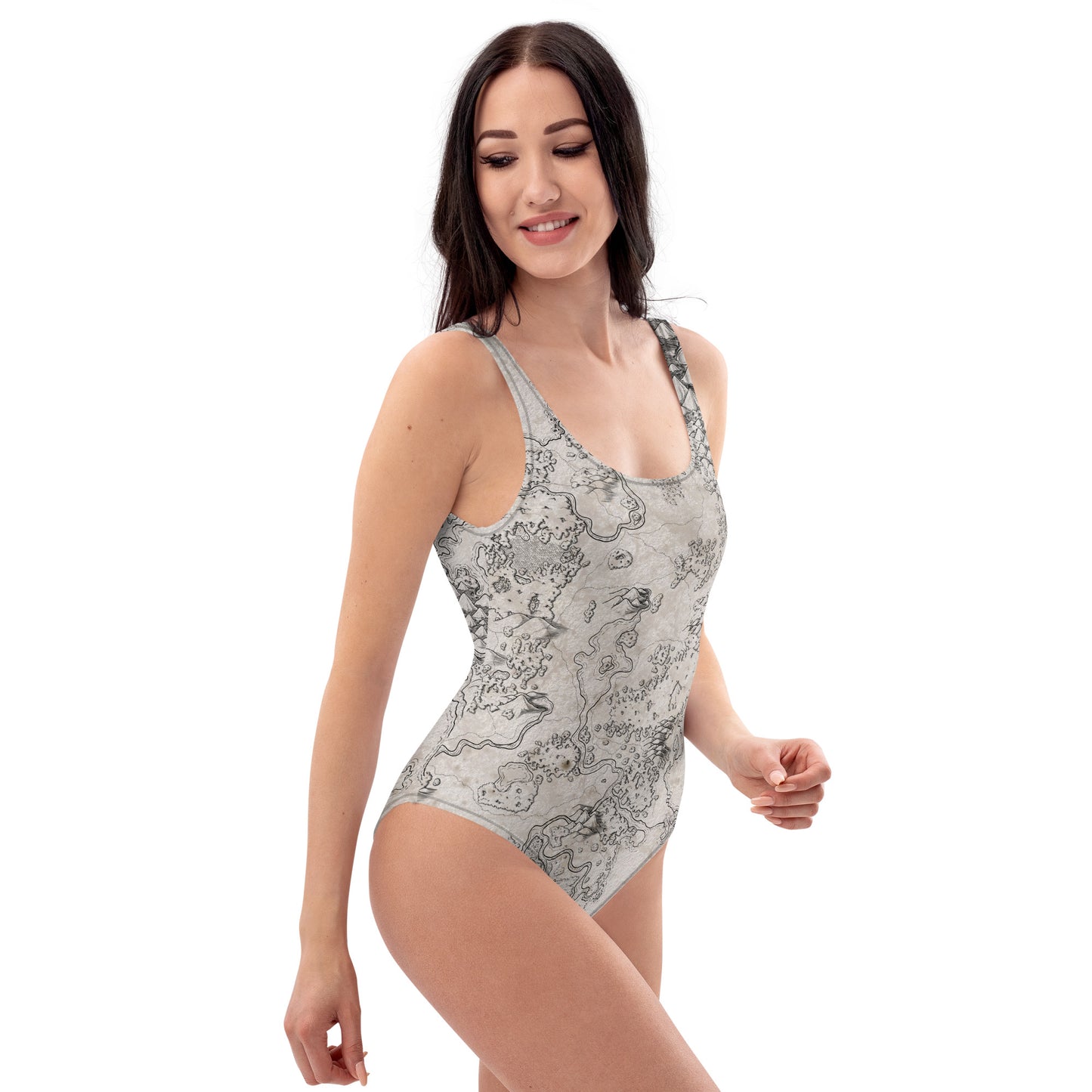 A model wears the Wallerfen map one piece swimsuit by Deven Rue, side view.