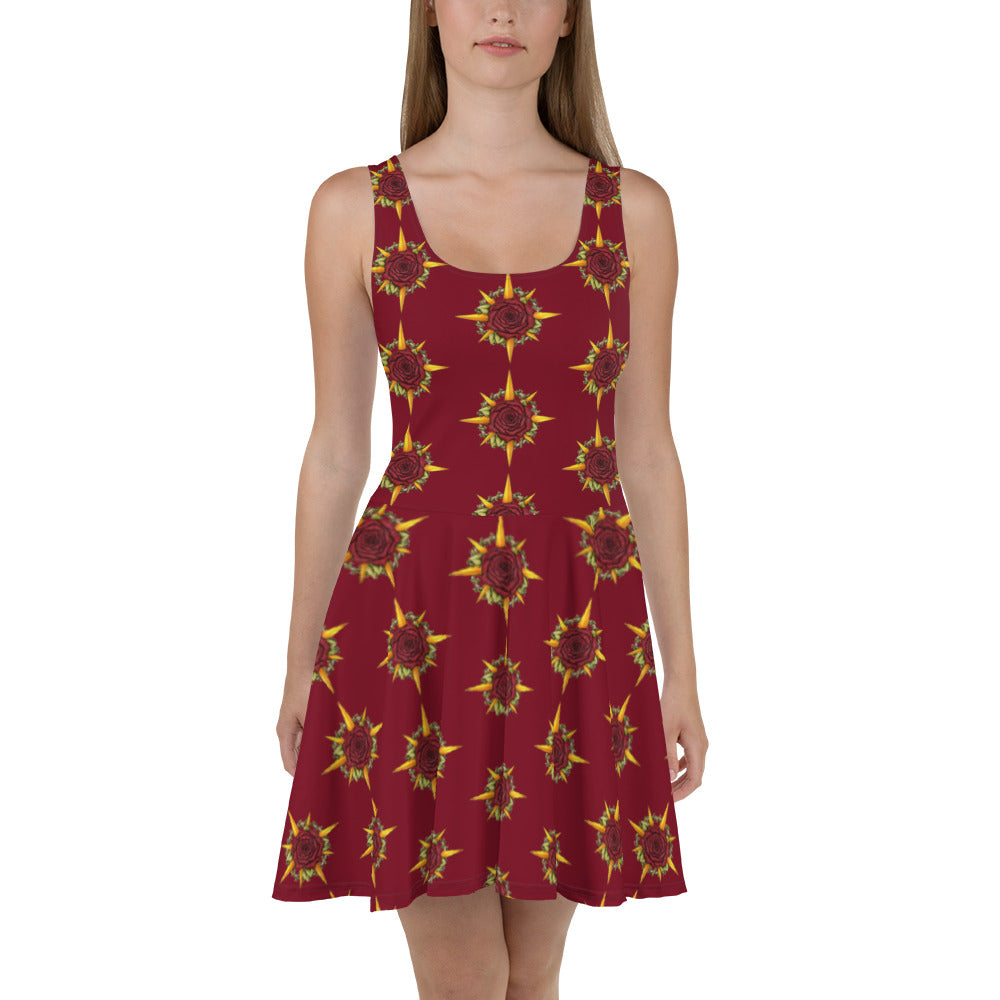 A model wears a skater skirt tank dress in burgundy with the Druid Compass Rose ibn a pattern all over it, front view.