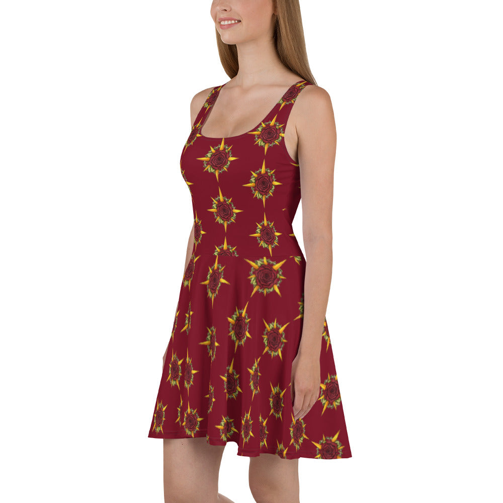 A model wears a skater skirt tank dress in burgundy with the Druid Compass Rose ibn a pattern all over it.