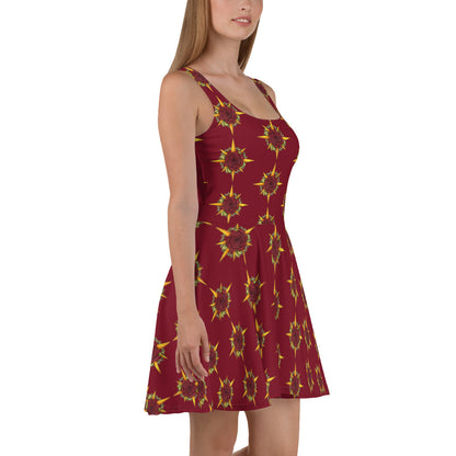 A model wears a skater skirt tank dress in burgundy with the Druid Compass Rose ibn a pattern all over it, side view.