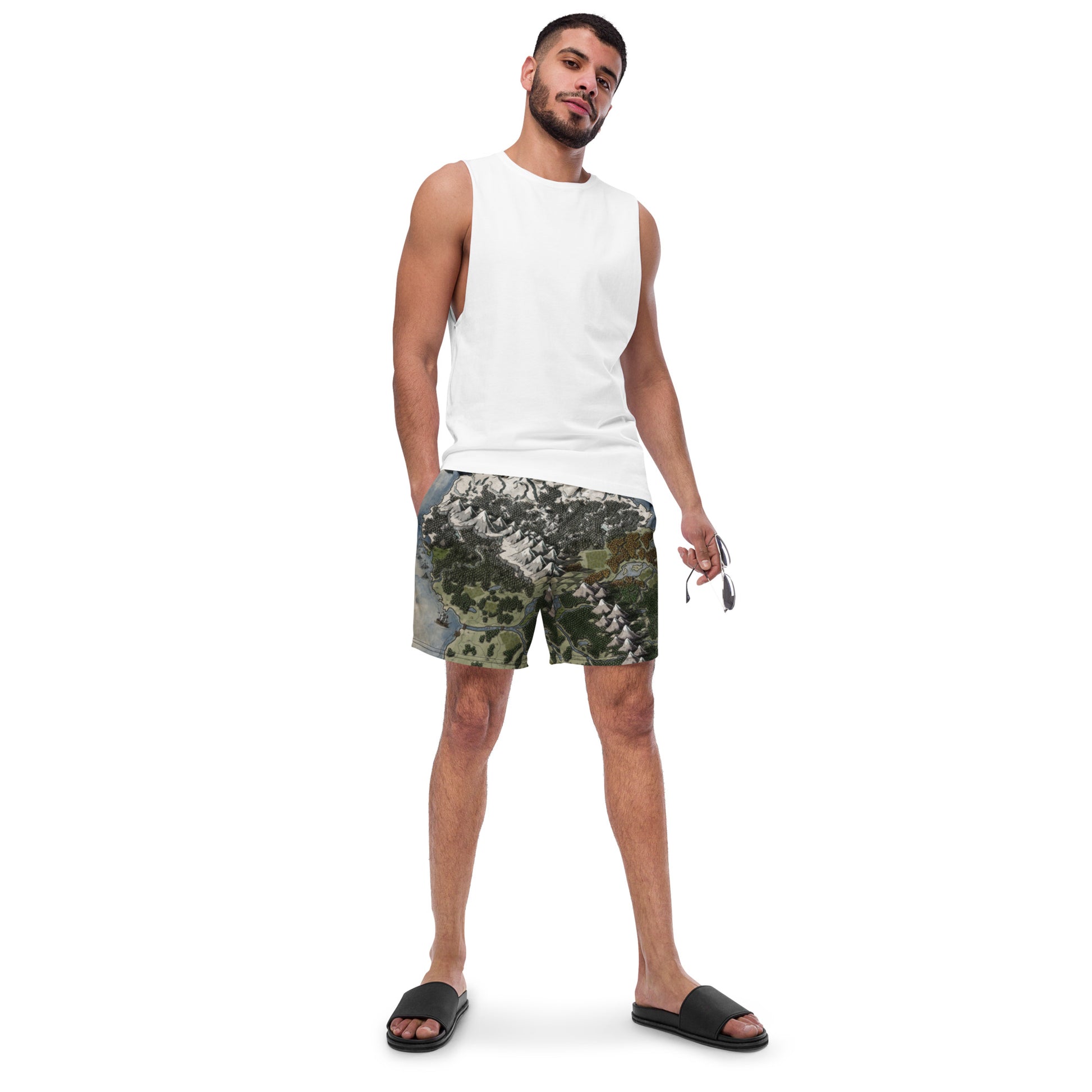 A model wears the Vendras map by Deven Rue on swim trunks with a tank top and sandals.