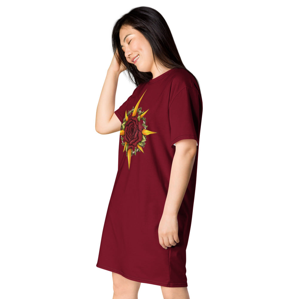 A model wears a burgundy t-shirt dress with the Druid Compass Rose illustration on the front, side view.