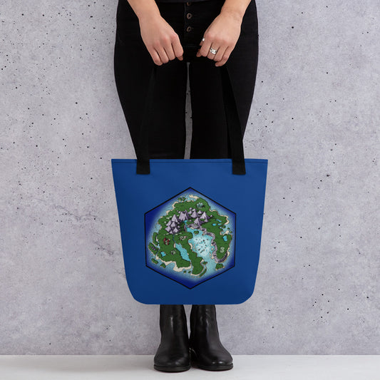 A model holds a tote bag with an illustrated island treasure map in the shape of a hexagon on a blue background.