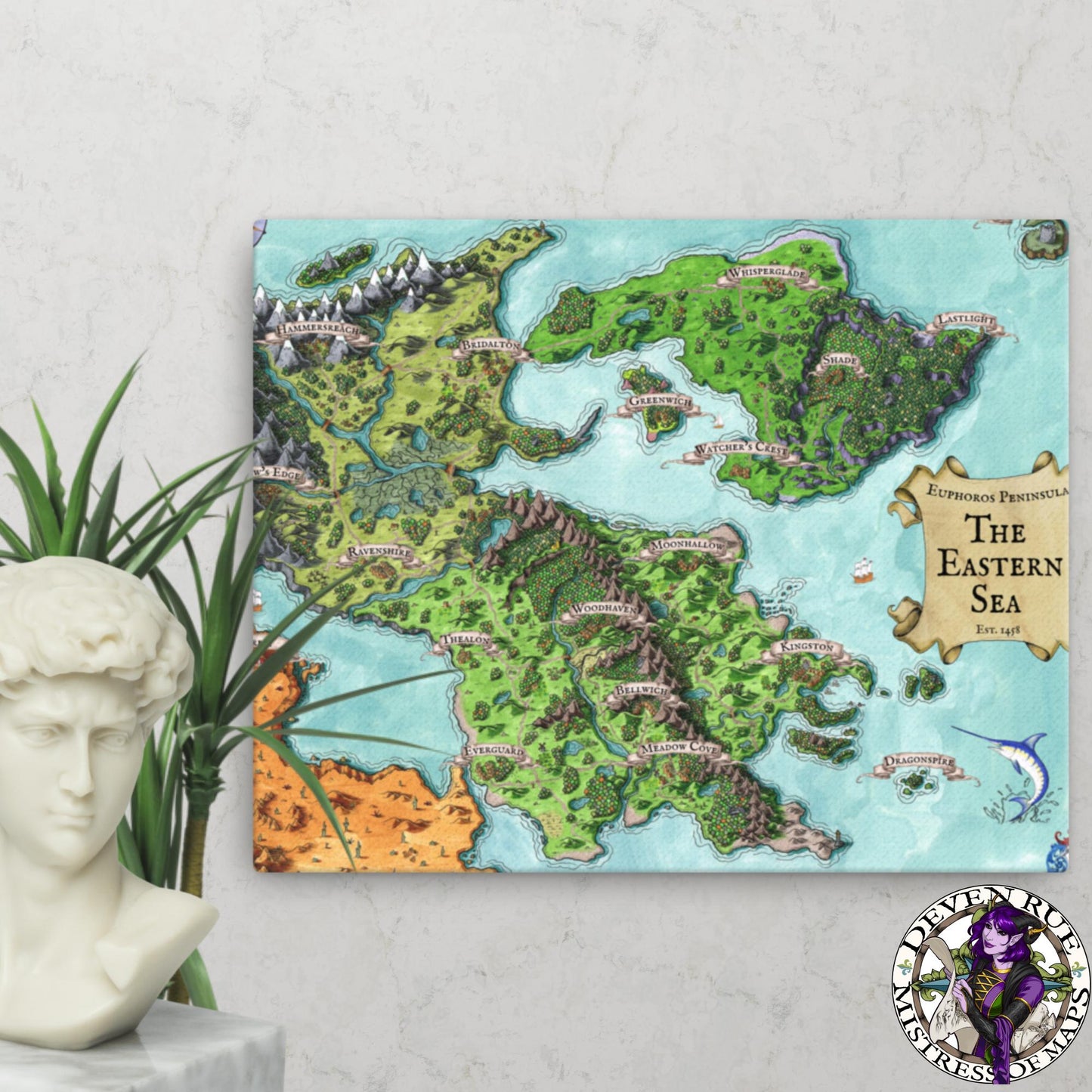 A 16" by 20" canvas print of the Euphoros map by Deven Rue hangs on a wall behind a plant and a bust statue.