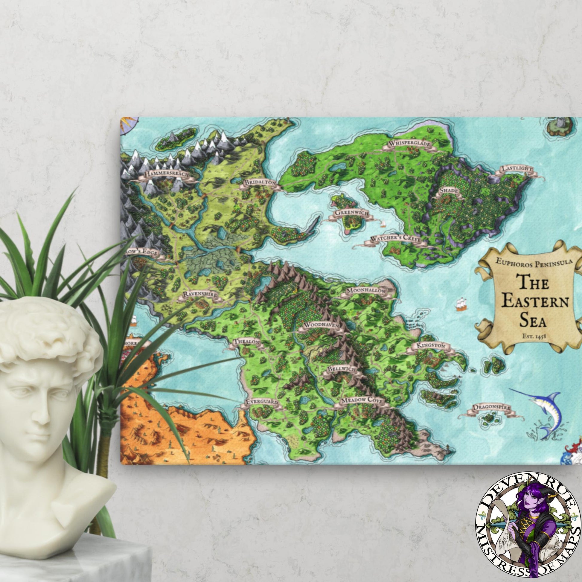 A 18" by 24" canvas print of the Euphoros map by Deven Rue hangs on a wall behind a plant and a bust statue.