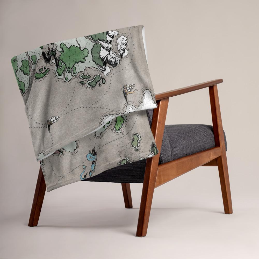 The Ortheiad map by Deven Rue is printed on a minky blanket which is folded neatly on the back of a chair.