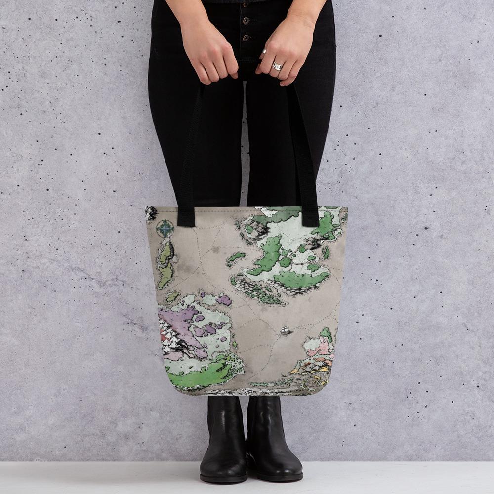 A model holds a tote bag featuring a colored map of sailing routes between land masses.