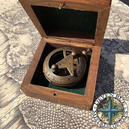 The box is open to show the compass and sundial in the box.