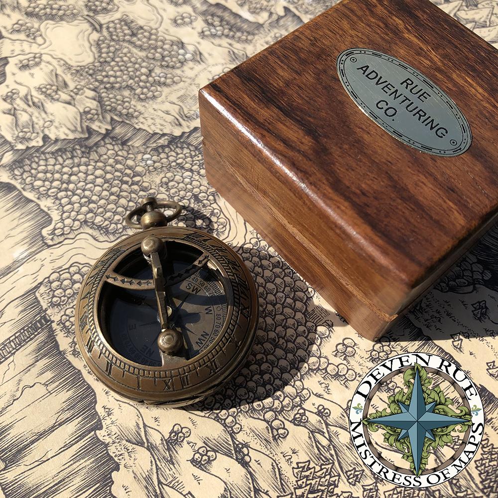 The compass and sundial next to the box on the map.