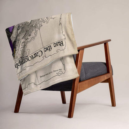 Rue the Cartographer throw blanket by Deven Rue draped over a chair.