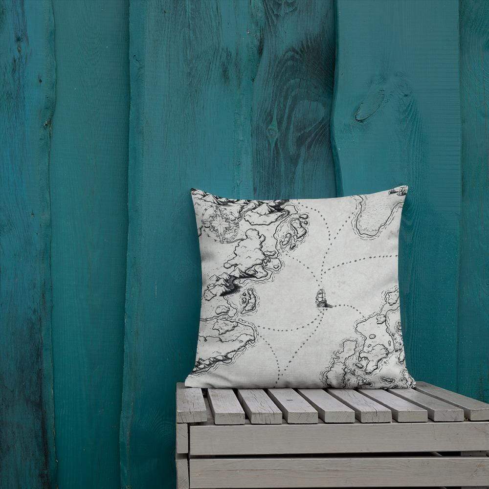The Sailing into the Unknown map by Deven Rue on a pillow, sitting on an ourdoor bench.