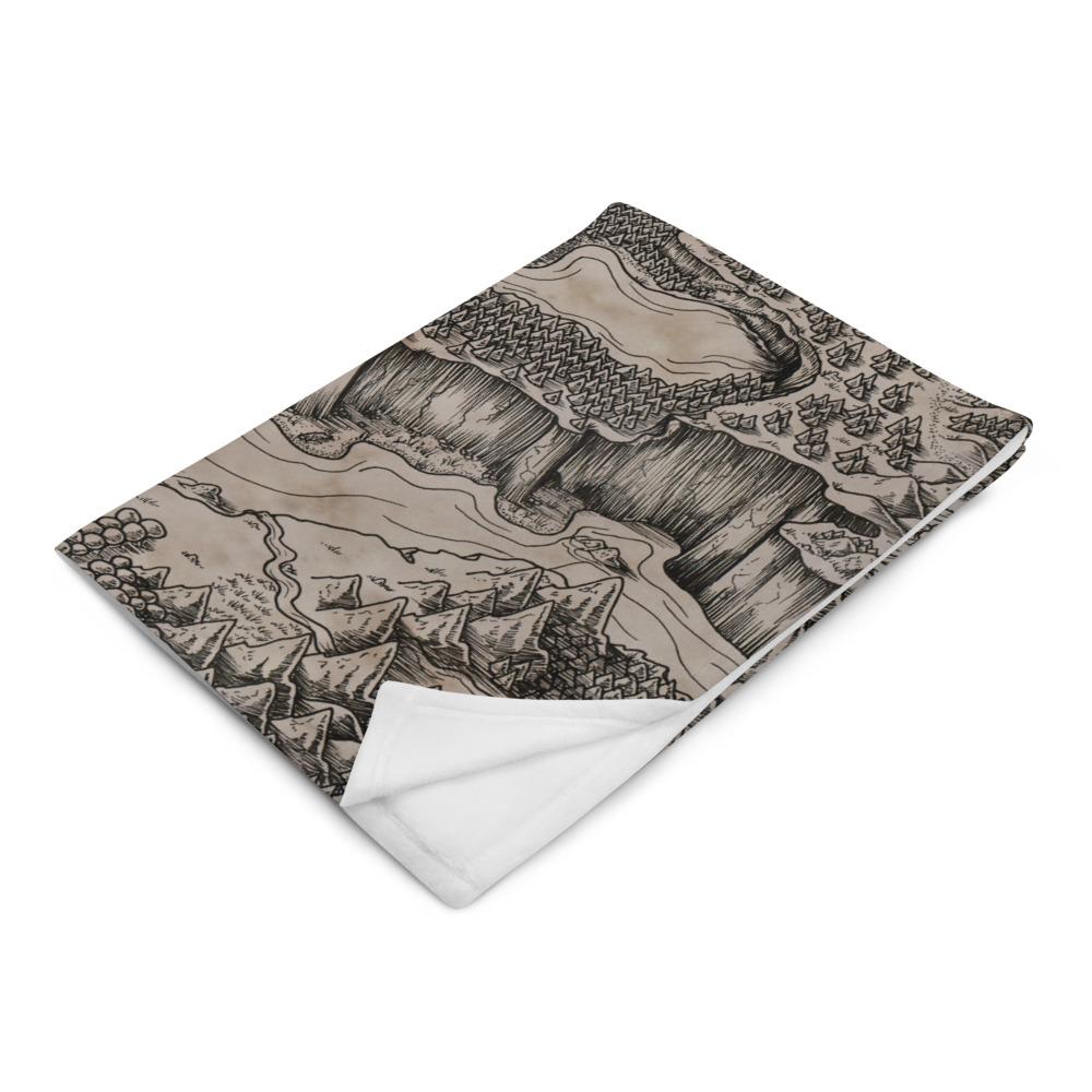 The Steppes of Augrudeen parchment map by Deven Rue is printed on a minky blanket, folded up.